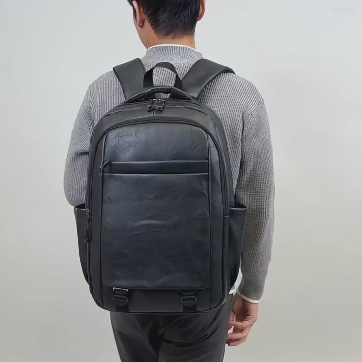MYMODAGLAM PU Leather Backpack — man wearing black leather backpack, rear view showing full bag design and straps